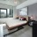 spacious bedroom with a large window and on wood-style flooring