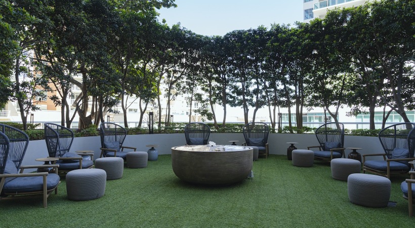 find your Zen at Midtown 5 grassy area with a fountain and chairs around it