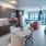 interior shot of studio apartment with large windows and access to private balcony