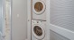 stackable washer/dryer in laundry closet next to bathroom
